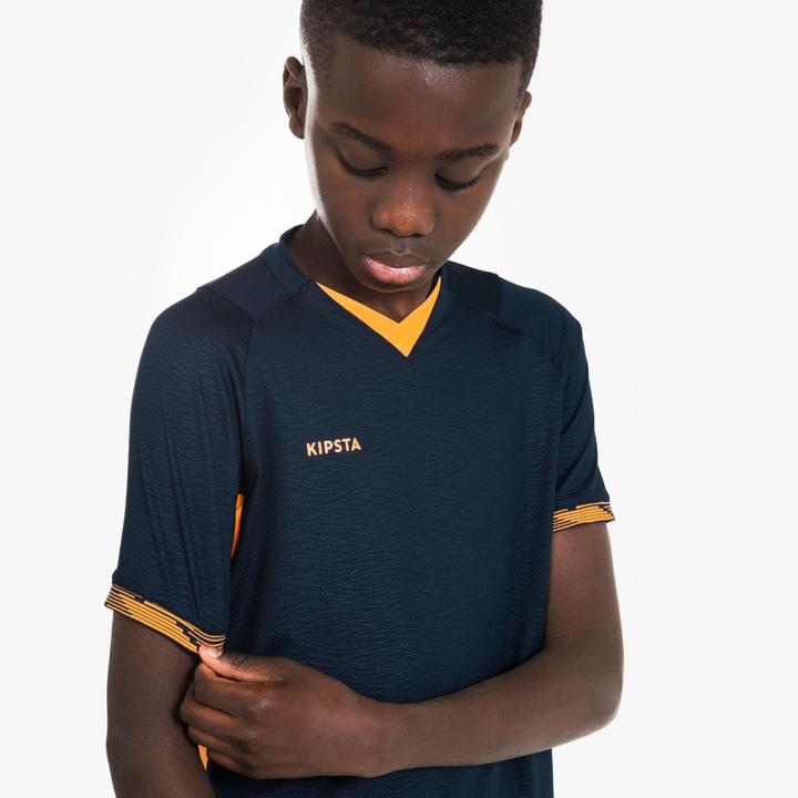 Immagine prodotto Kipsta Maglia da calcio per bambini a maniche corte - CLR arancione/blu scuro (12, 13, 14)