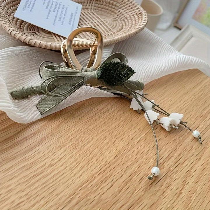 Actual product image Activity Board 1 Stück Elegante französische Maiglöckchen-Haarspange mit Quaste ist eine schicke Spange (1 pcs.)