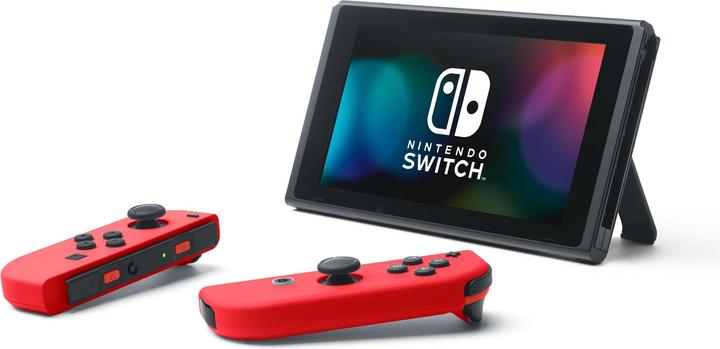 Immagine prodotto Nintendo Switch Rosso + Codice per il download di Super Mario Odyssey + Adesivo del film di Super Mario Bros.